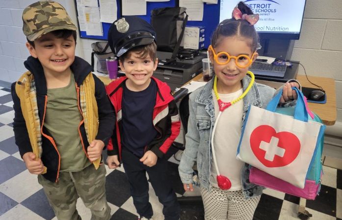  3 students smiling.